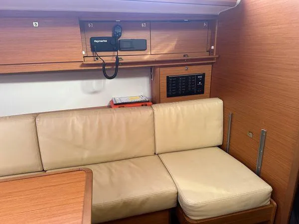 Epiphany Yacht Photos Pics Interior of 2022 Dufour 430 yacht with beige seating and wooden cabinetry.