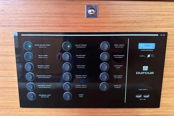 Epiphany Yacht Photos Pics Control panel of a 2022 Dufour 430 yacht with labeled switches and indicators.