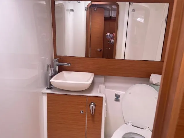 Epiphany Yacht Photos Pics Modern bathroom in 2022 Dufour 430 yacht with sink, mirror, and toilet.