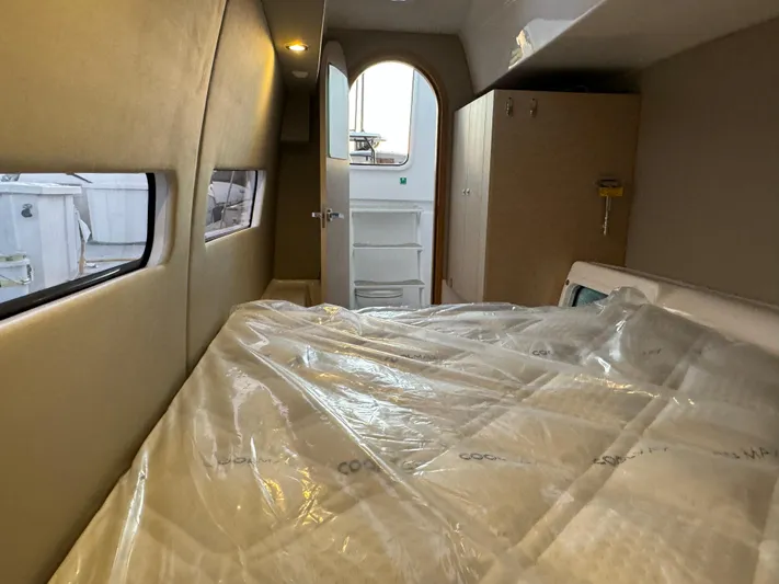 Stock Neel 47 Yacht Photos Pics Interior cabin of 2023 NEEL 47 yacht with bed and windows.