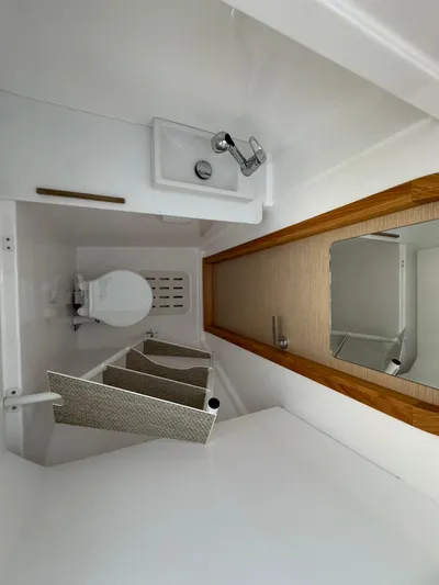 Stock Neel 47 Yacht Photos Pics 2023 NEEL 47 yacht bathroom with sink, toilet, and mirror.