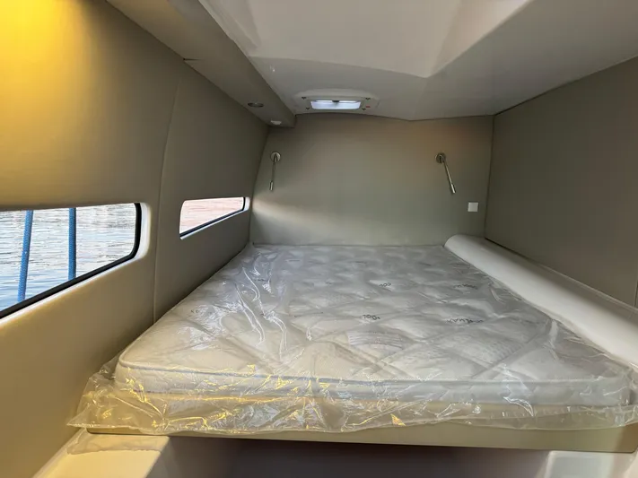 Stock Neel 47 Yacht Photos Pics Interior cabin of 2023 NEEL 47 with a bed and window view.