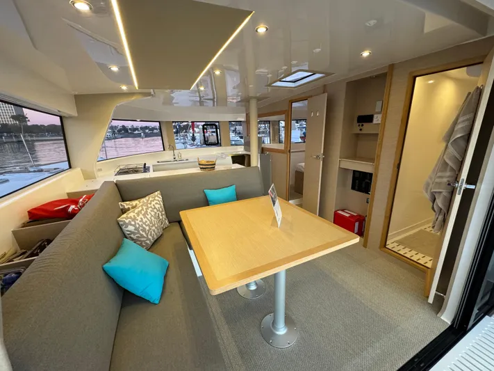 Stock Neel 47 Yacht Photos Pics Modern NEEL 47 catamaran interior with cozy seating and dining area, 2023 model.