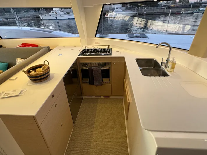 Stock Neel 47 Yacht Photos Pics Modern NEEL 47 yacht kitchen with stove, sink, and waterfront view, 2023 model.