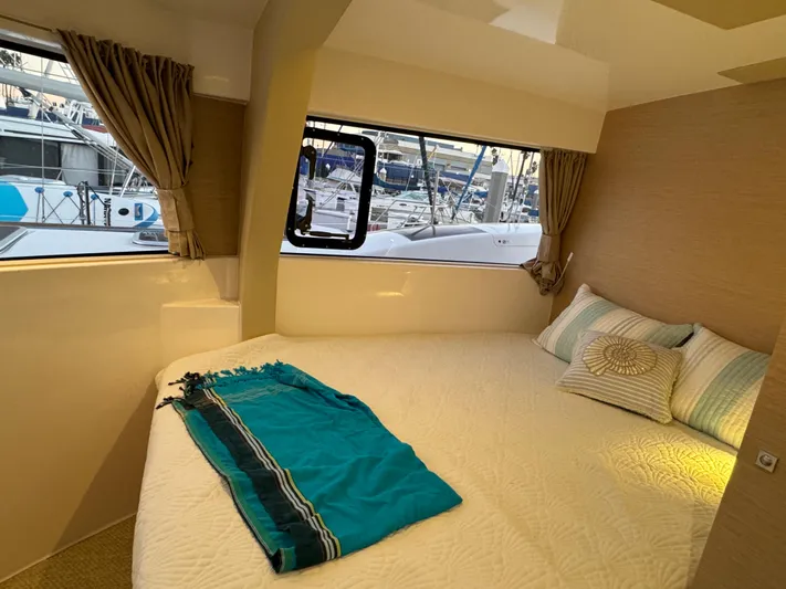 Stock Neel 47 Yacht Photos Pics Cozy cabin interior of 2023 NEEL 47 trimaran with marina view.