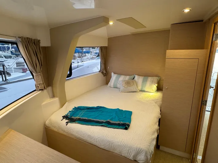 Stock Neel 47 Yacht Photos Pics Cozy bedroom interior of 2023 NEEL 47 yacht with window view and modern decor.
