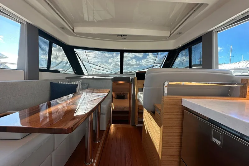 Pal Agua Yacht Photos Pics Interior of 2023 Tiara Yachts C39 Coupe, featuring elegant seating and wooden finishes.