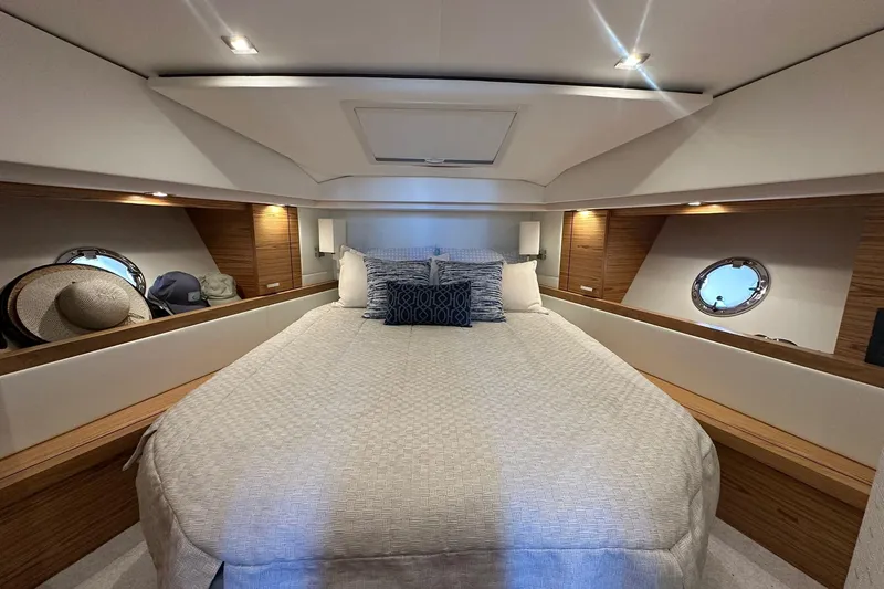 Pal Agua Yacht Photos Pics Luxurious 2023 Tiara Yachts C39 Coupe cabin with elegant bedding and stylish wood accents.