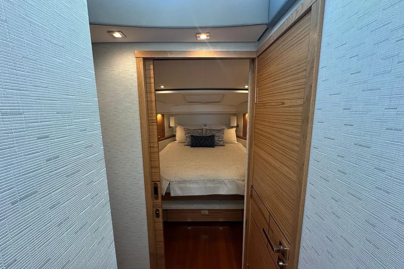 Pal Agua Yacht Photos Pics Luxurious bedroom interior of 2023 Tiara Yachts C39 Coupe, featuring elegant wood finishes.