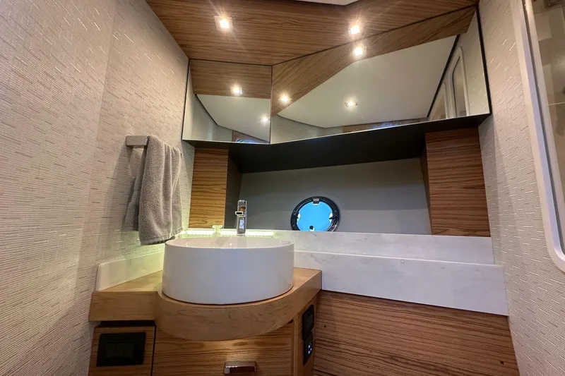 Pal Agua Yacht Photos Pics Luxurious bathroom interior of 2023 Tiara Yachts C39 Coupe with modern fixtures and wood accents.
