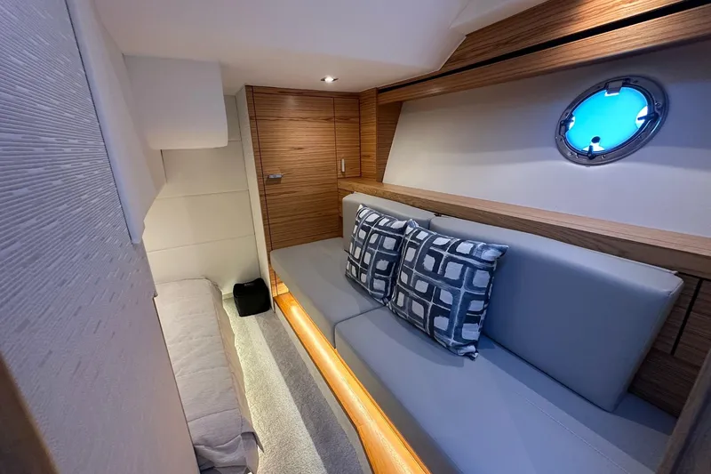 Pal Agua Yacht Photos Pics Luxurious interior of 2023 Tiara Yachts C39 Coupe with modern seating and porthole.
