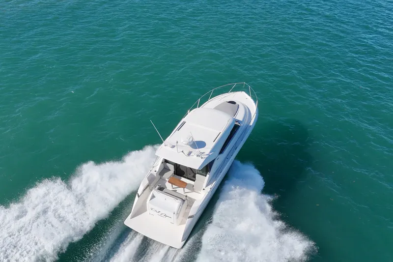 Pal Agua Yacht Photos Pics 2023 Tiara Yachts C39 Coupe cruising on open water, aerial view.