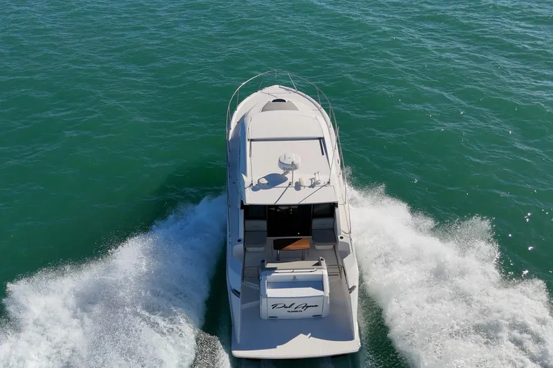Pal Agua Yacht Photos Pics 2023 Tiara Yachts C39 Coupe cruising on open water, aerial view.