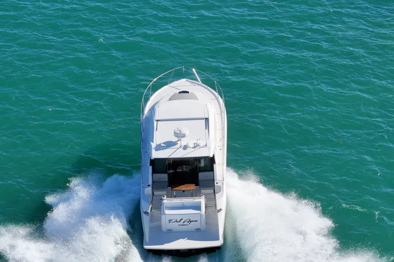 Pal Agua Yacht Photos Pics 2023 Tiara Yachts C39 Coupe cruising on vibrant blue water.