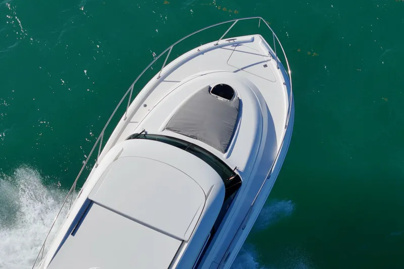 Pal Agua Yacht Photos Pics 2023 Tiara Yachts C39 Coupe cruising on turquoise water, aerial view.