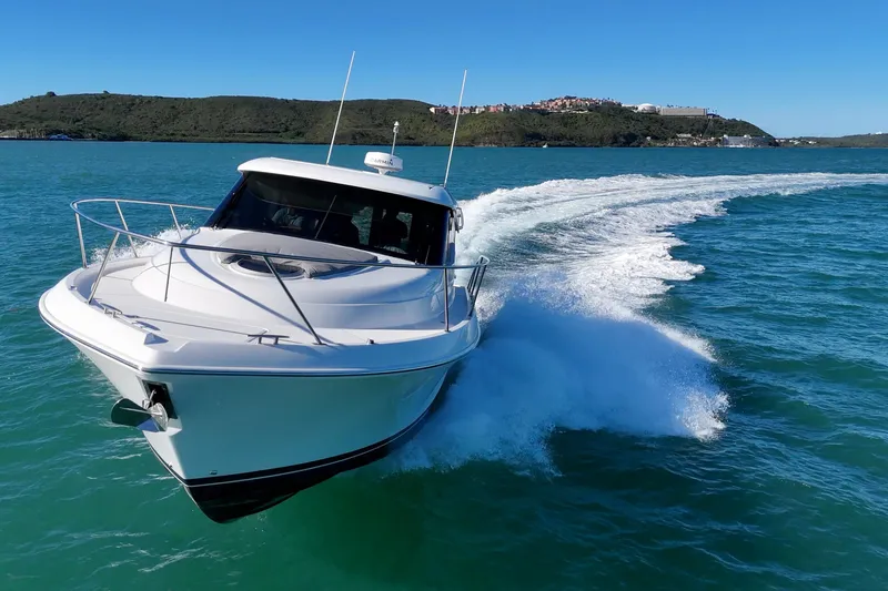 Pal Agua Yacht Photos Pics 2023 Tiara Yachts C39 Coupe cruising on clear blue water.