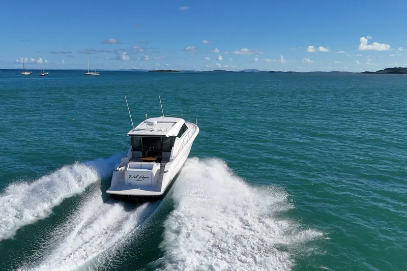 Pal Agua Yacht Photos Pics 2023 Tiara Yachts C39 Coupe cruising on open sea under clear blue sky.