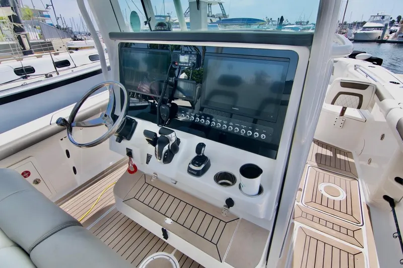  Yacht Photos Pics 2023 World Cat 325 CC boat cockpit with modern controls and steering wheel.