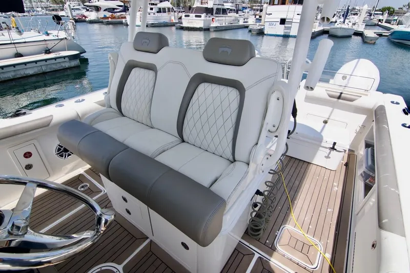  Yacht Photos Pics 2023 World Cat 325 CC boat interior with luxurious seating and marina view.