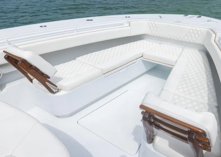  Yacht Photos Pics Luxurious seating on 2025 Invincible 43 Open Fisherman boat, featuring white cushioned benches.