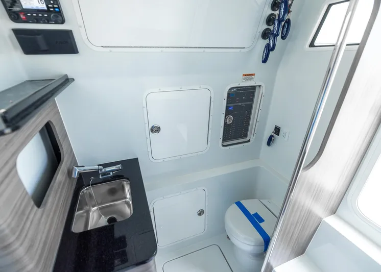  Yacht Photos Pics 2025 Invincible 43 Open Fisherman boat interior with sink, toilet, and control panel.