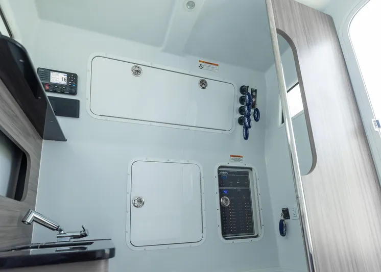  Yacht Photos Pics 2025 Invincible 43 Open Fisherman interior with control panel and storage compartments.