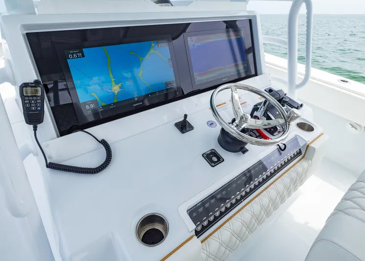  Yacht Photos Pics Control panel of 2025 Invincible 43 Open Fisherman with navigation screens and steering wheel.