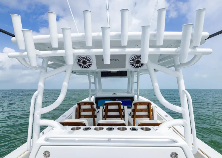  Yacht Photos Pics 2025 Invincible 43 Open Fisherman boat with rod holders and seating, on open water.