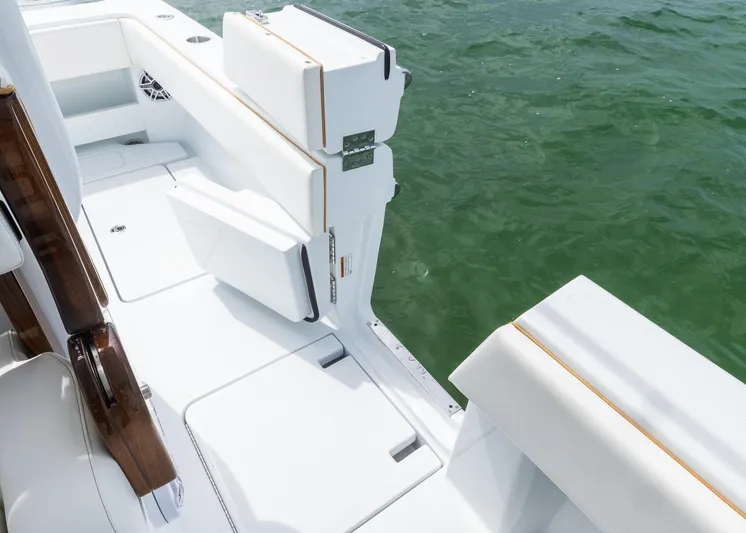  Yacht Photos Pics 2025 Invincible 43 Open Fisherman boat, white deck, near water, featuring sleek seating and modern design.