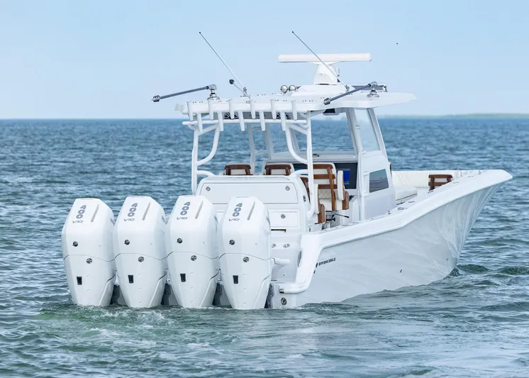  Yacht Photos Pics 2025 Invincible 43 Open Fisherman boat with four powerful outboard engines on the ocean.