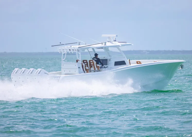  Yacht Photos Pics 2025 Invincible 43 Open Fisherman boat cruising on the ocean.