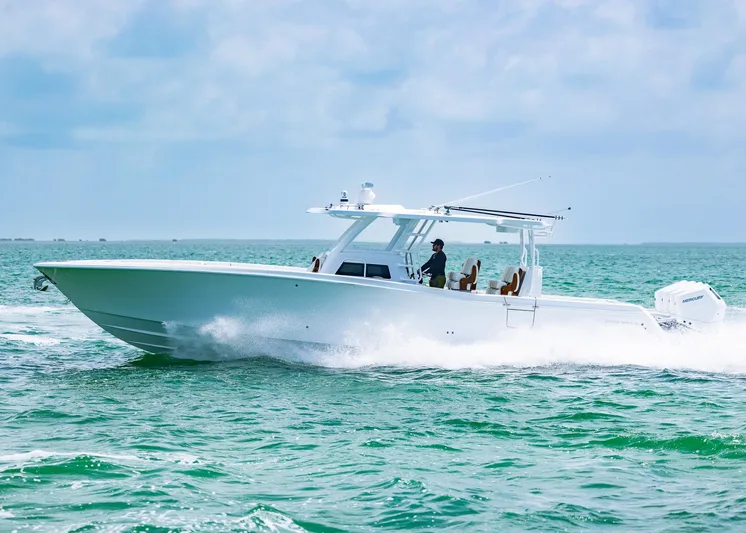  Yacht Photos Pics 2025 Invincible 43 Open Fisherman boat cruising on open water.