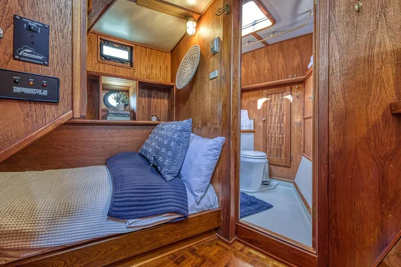  Yacht Photos Pics Cozy wooden cabin interior with bed and bathroom, Nielsen 46, 1981 model.