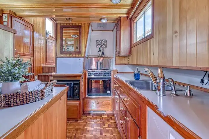  Yacht Photos Pics Wooden kitchen interior of 1981 Nielsen model 46 boat with modern appliances.