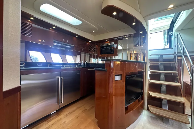 Knot Rite Yacht Photos Pics Luxurious interior of 2009 Sea Ray 60 Sundancer yacht with modern kitchen and staircase.
