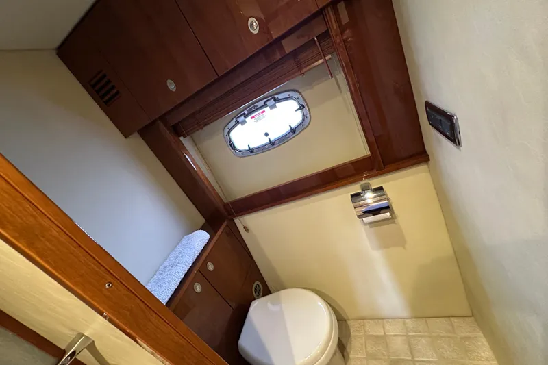 Knot Rite Yacht Photos Pics Luxurious bathroom interior of 2009 Sea Ray 60 Sundancer yacht with wooden cabinetry.