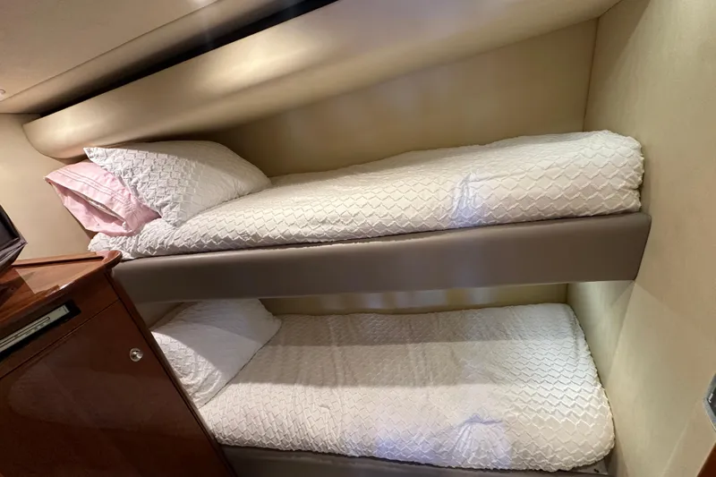 Knot Rite Yacht Photos Pics Bunk beds in 2009 Sea Ray 60 Sundancer yacht cabin, featuring white bedding.