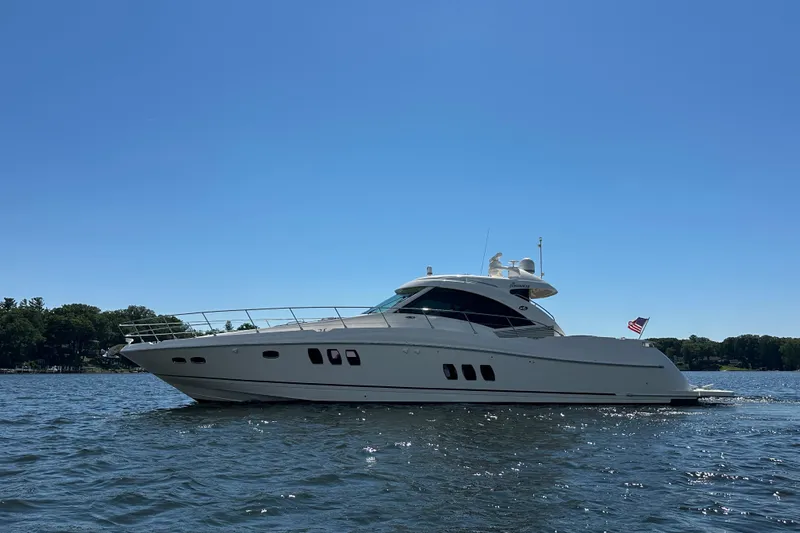 Knot Rite Yacht Photos Pics 2009 Sea Ray 60 Sundancer yacht cruising on a sunny day, with clear blue skies.