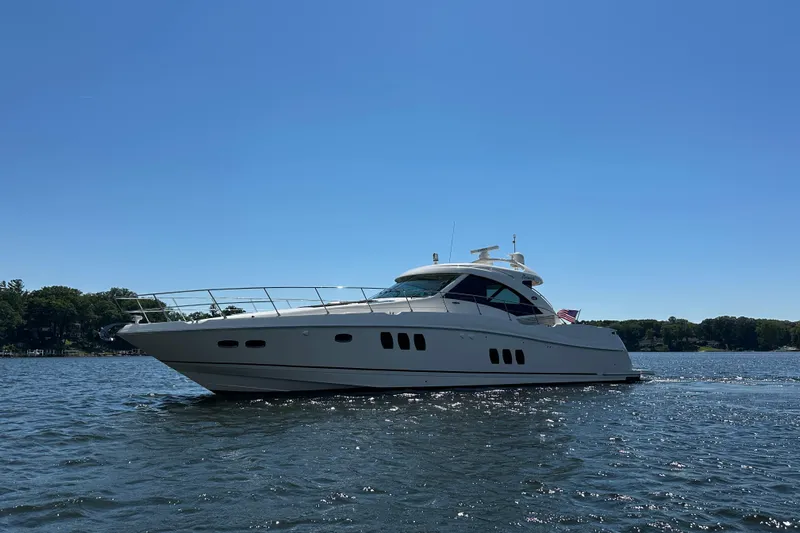 Knot Rite Yacht Photos Pics 2009 Sea Ray 60 Sundancer yacht cruising on a sunny day, surrounded by calm waters.