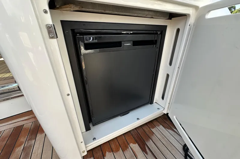 Knot Rite Yacht Photos Pics Built-in refrigerator on 2009 Sea Ray 60 Sundancer yacht, featuring sleek design and wooden flooring.