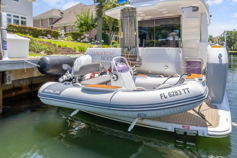 Tangerine Moon Yacht Photos Pics Azimut Magellano 43 yacht with tender boat docked in a scenic marina, 2014 model.