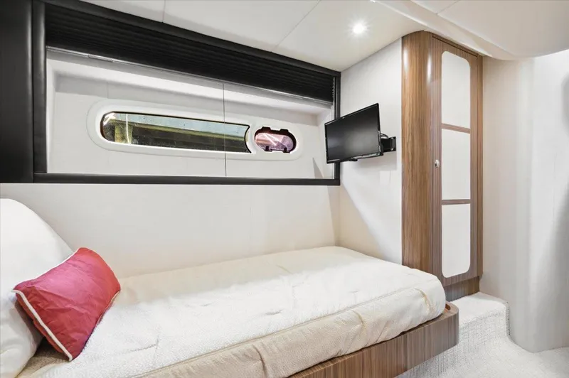 Tangerine Moon Yacht Photos Pics Luxurious cabin interior of 2014 Azimut Magellano 43 yacht with bed and TV.