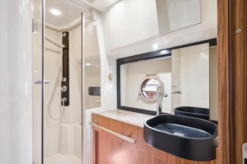 Tangerine Moon Yacht Photos Pics Luxurious bathroom in 2014 Azimut Magellano 43 yacht with modern fixtures and elegant design.