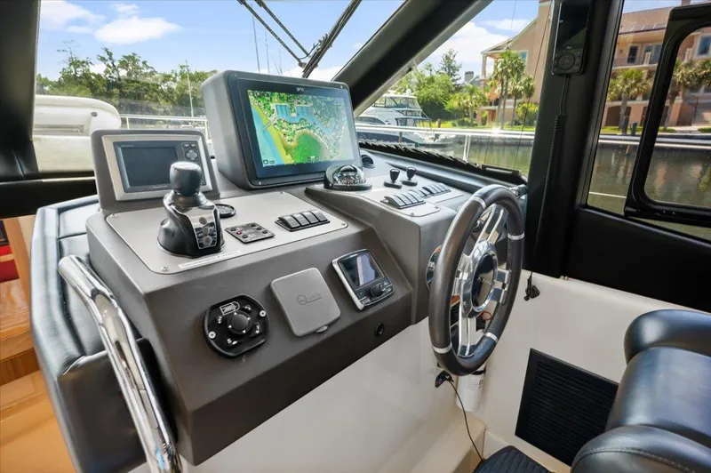 Tangerine Moon Yacht Photos Pics Cockpit of 2014 Azimut Magellano 43 yacht with navigation equipment and steering wheel.