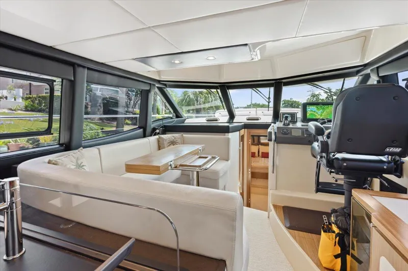 Tangerine Moon Yacht Photos Pics Luxurious interior of 2014 Azimut Magellano 43 yacht with modern seating and navigation area.