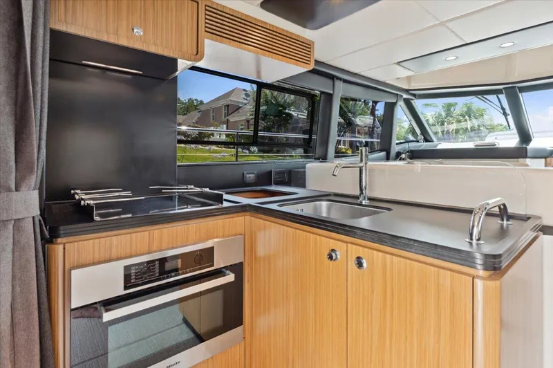 Tangerine Moon Yacht Photos Pics Modern kitchen interior of 2014 Azimut Magellano 43 yacht with sleek design and appliances.