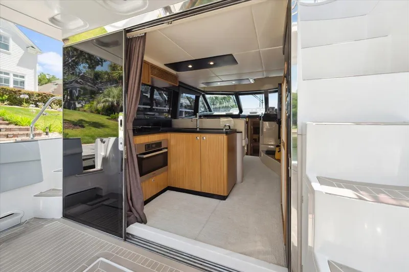 Tangerine Moon Yacht Photos Pics Interior view of 2014 Azimut Magellano 43 yacht, featuring modern kitchen and spacious design.