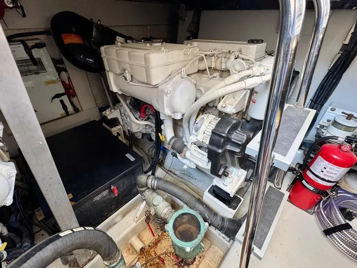 Tangerine Moon Yacht Photos Pics Engine room of 2014 Azimut Magellano 43 yacht, featuring mechanical components and fire extinguisher.