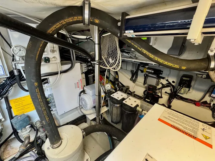 Tangerine Moon Yacht Photos Pics Engine room of 2014 Azimut Magellano 43 yacht, showcasing hoses and equipment.