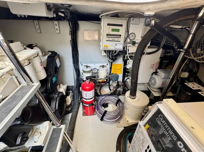 Tangerine Moon Yacht Photos Pics Engine room of 2014 Azimut Magellano 43 yacht with Cummins generator and safety equipment.